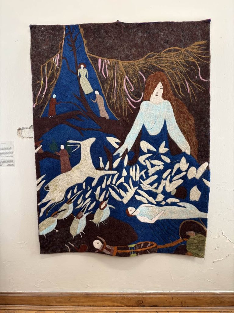 Embroidered tapestry Dress of a Thousand Oceans by Gvantsa Jishkariani featuring a female figure merging with water.